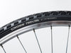 A close-up of a bicycle tire displaying the text "cross 700x32" on its sidewall.