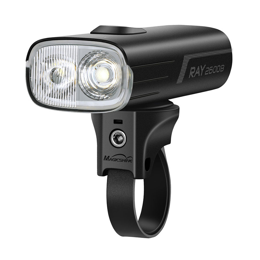 A close-up of the Magicshine RAY 2600B light's dual lens and bright LEDs, showcasing its powerful illumination capability.