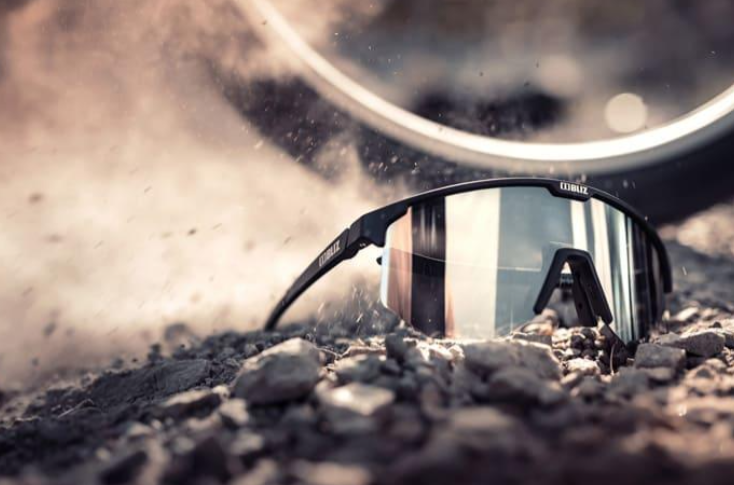 Bliz Hero Black Sport sunglasses lying on the ground, highlighting their modern and athletic appearance