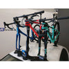 Car roof equipped with a bicycle rack holding a bike, showcasing the TreeFrog 9QR-15X100mm Thru Axle Fork Mount Bracket.