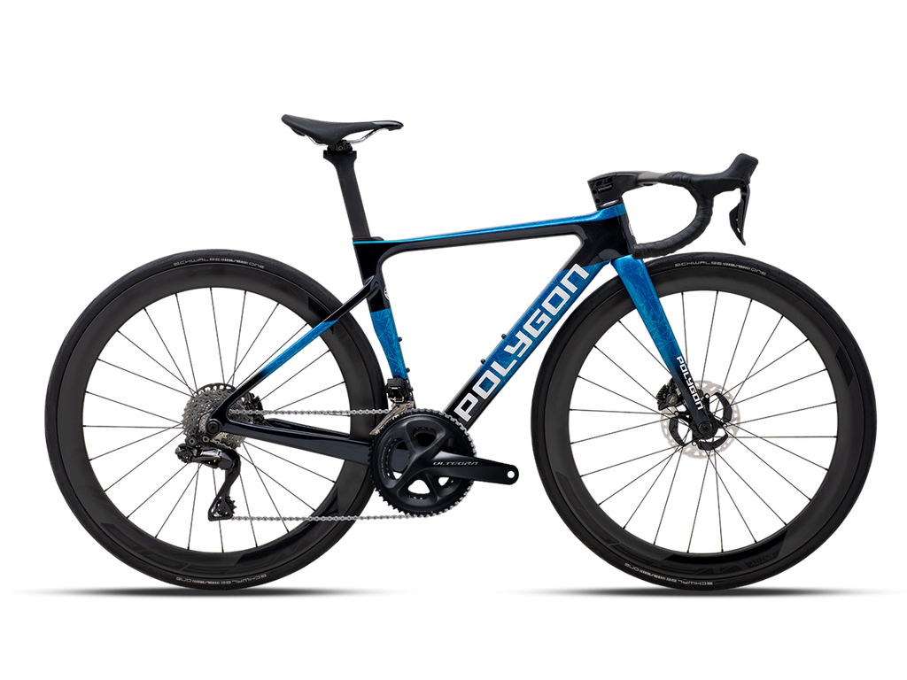 Polygon Helios A8X aero road bike with disc brakes and deep-section wheels, presented against a dark checkered background.