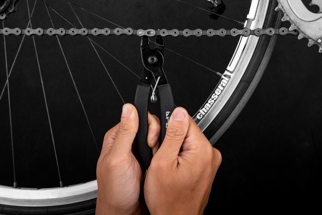 Close-up of the Birzman Link Plier, a two-sided tool for efficient bike chain maintenance