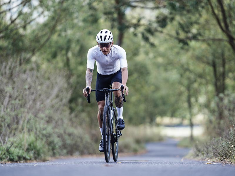 Cyclist riding a road bike on smooth tarmac