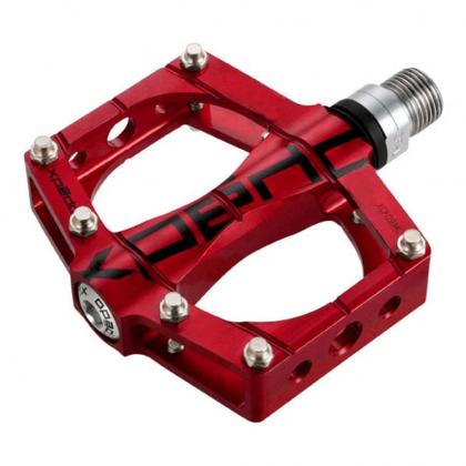 Close-up of Xpedo TRVS 9 pedal in red showing sealed bearing and chromoly spindle