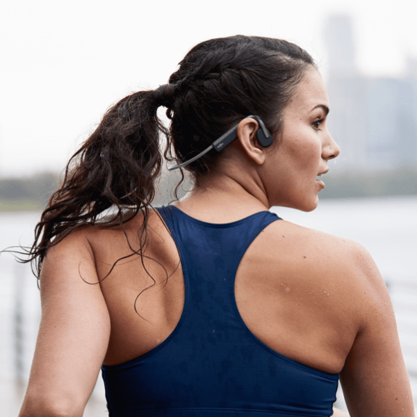 Shokz OpenMove Grey headphones shown with retail packaging and accessories.