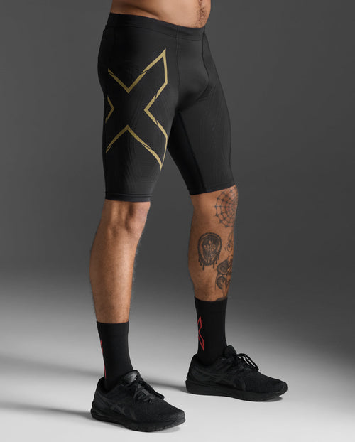2XU Light Speed Compression Shorts in Black/Gold Reflective, side view showing the gold X thigh logo.