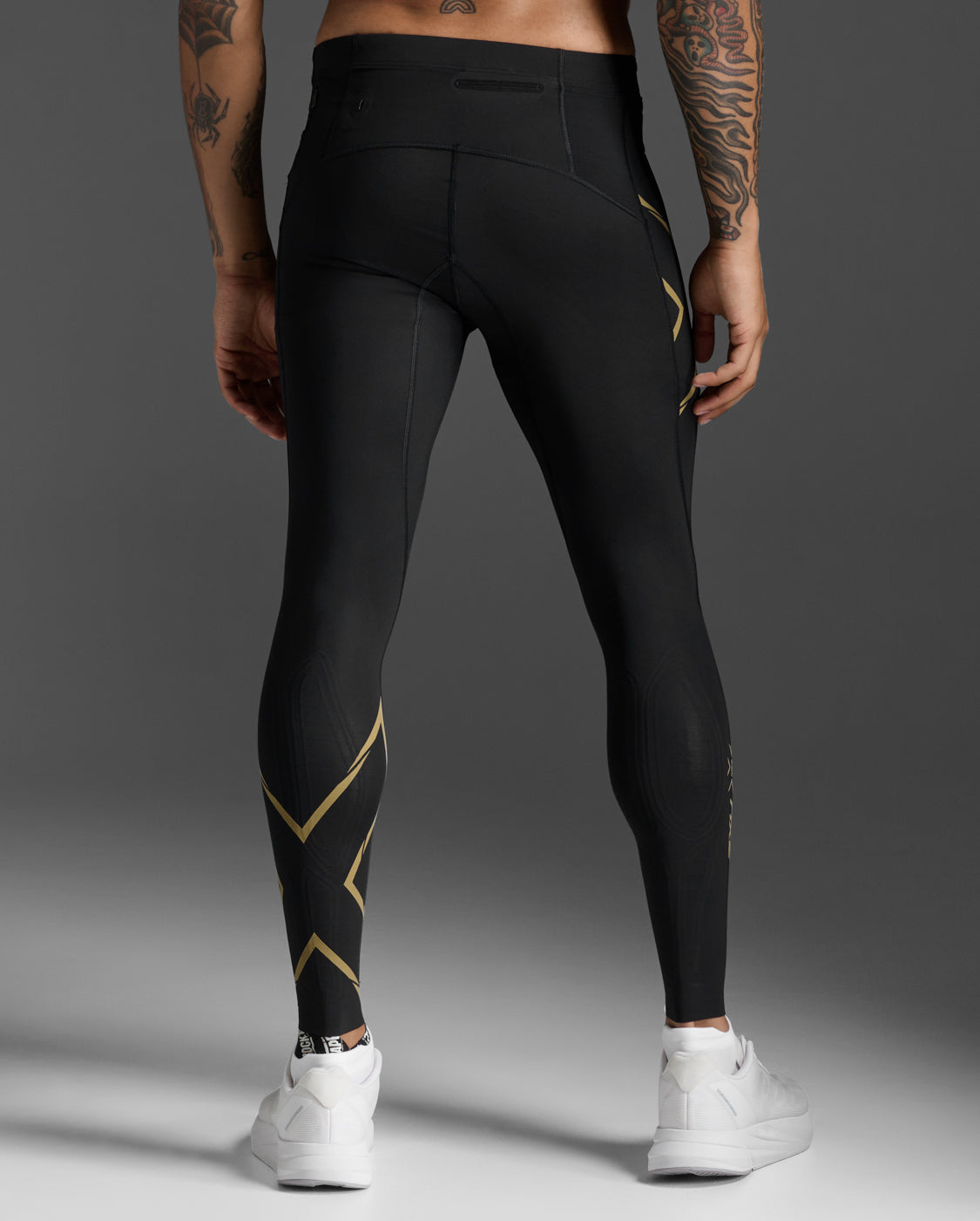 Rear view of the 2XU Light Speed Compression Tights showing the waistband pocket and gold reflective calf trim.