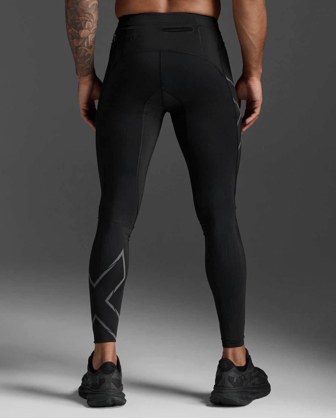 Rear view of the 2XU Light Speed Compression Tights in Black/Black Reflective showing the waistband pocket and reflective calf trim.
