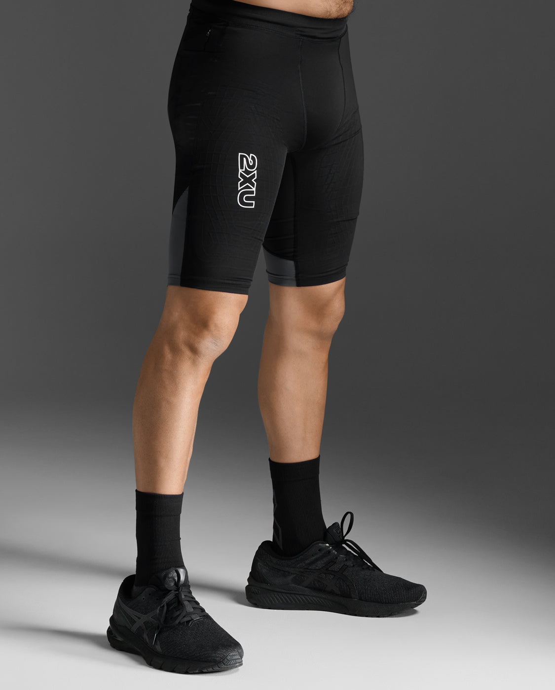 Side profile view of the 2XU Light Speed React Compression Shorts on a male model.