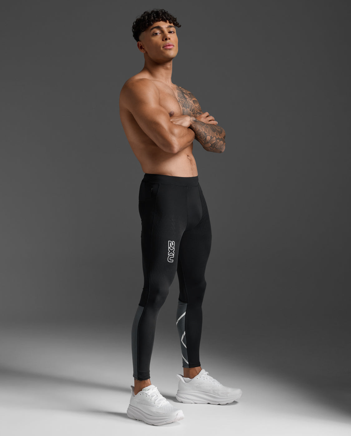 2XU Light Speed React Compression Tights in Black/White Reflective, side profile view on a male model.