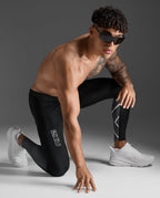 Male athlete wearing the 2XU Light Speed React Compression Tights in a kneeling sprint-start pose.