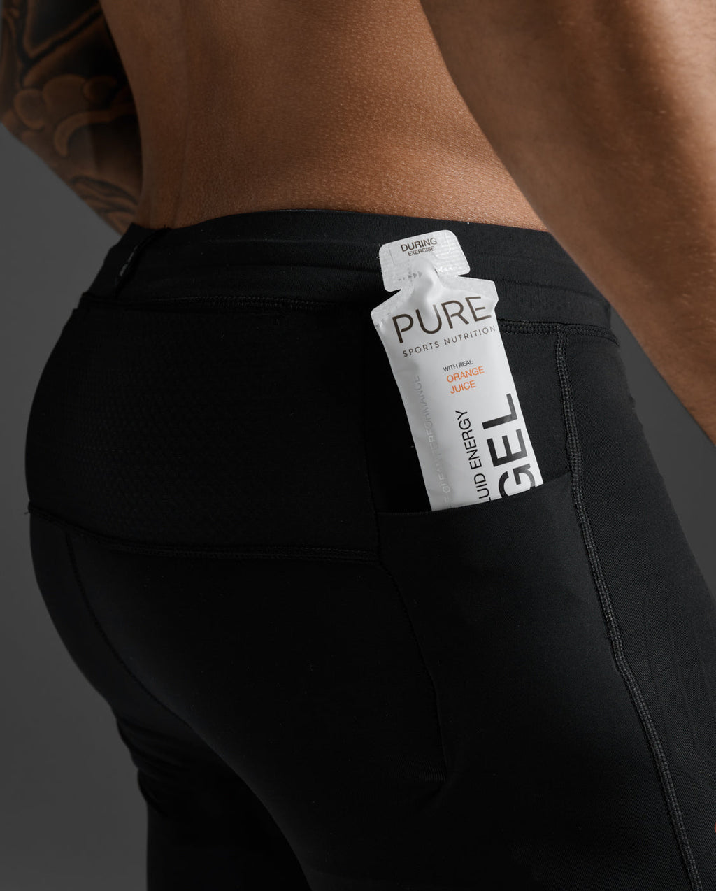 2XU Light Speed React Compression Tights rear pocket holding an energy gel for on-the-run nutrition access.