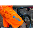 Santini MTB Selva Shorts, Flashy Orange, on-rider action shot.