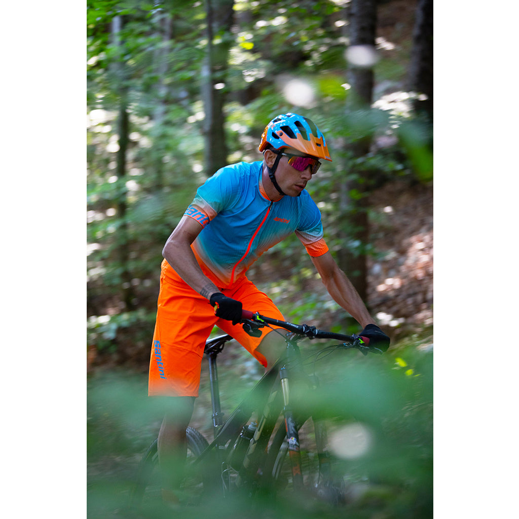 Santini MTB Selva Shorts, Flashy Orange, on-rider trail detail.