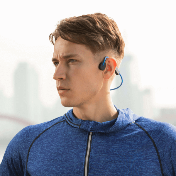 Shokz OpenMove Blue headphones shown with retail packaging and accessories.