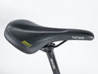 Close-up of a bicycle seat featuring the word "schweizer," with a red and black design by Author, model Bicycle Vertigo 18