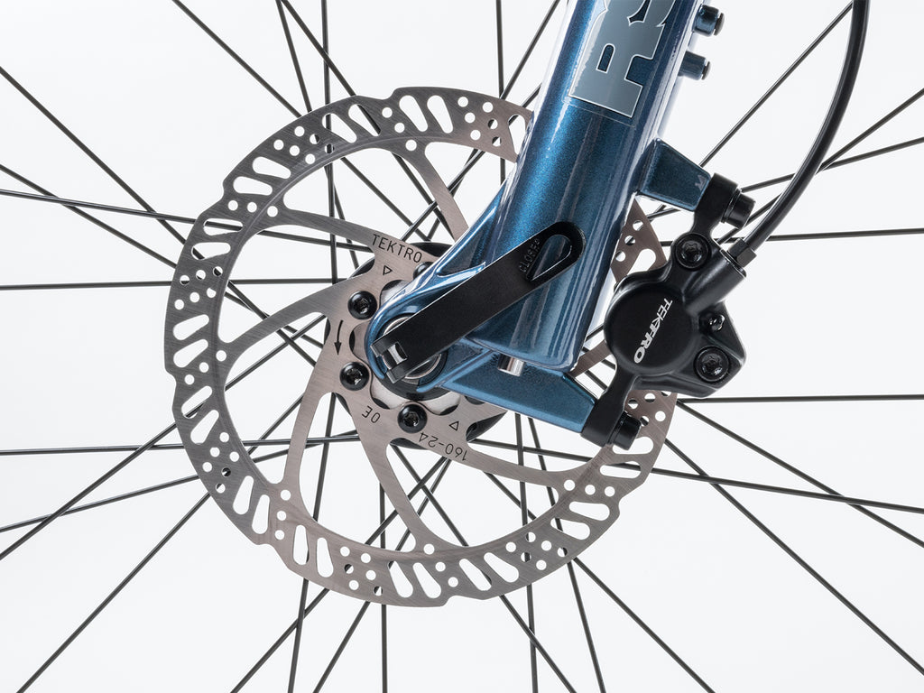  Rear disc brake on a mountain bike, featuring a red and black design, showcasing the brand Bicycle Vertigo.
