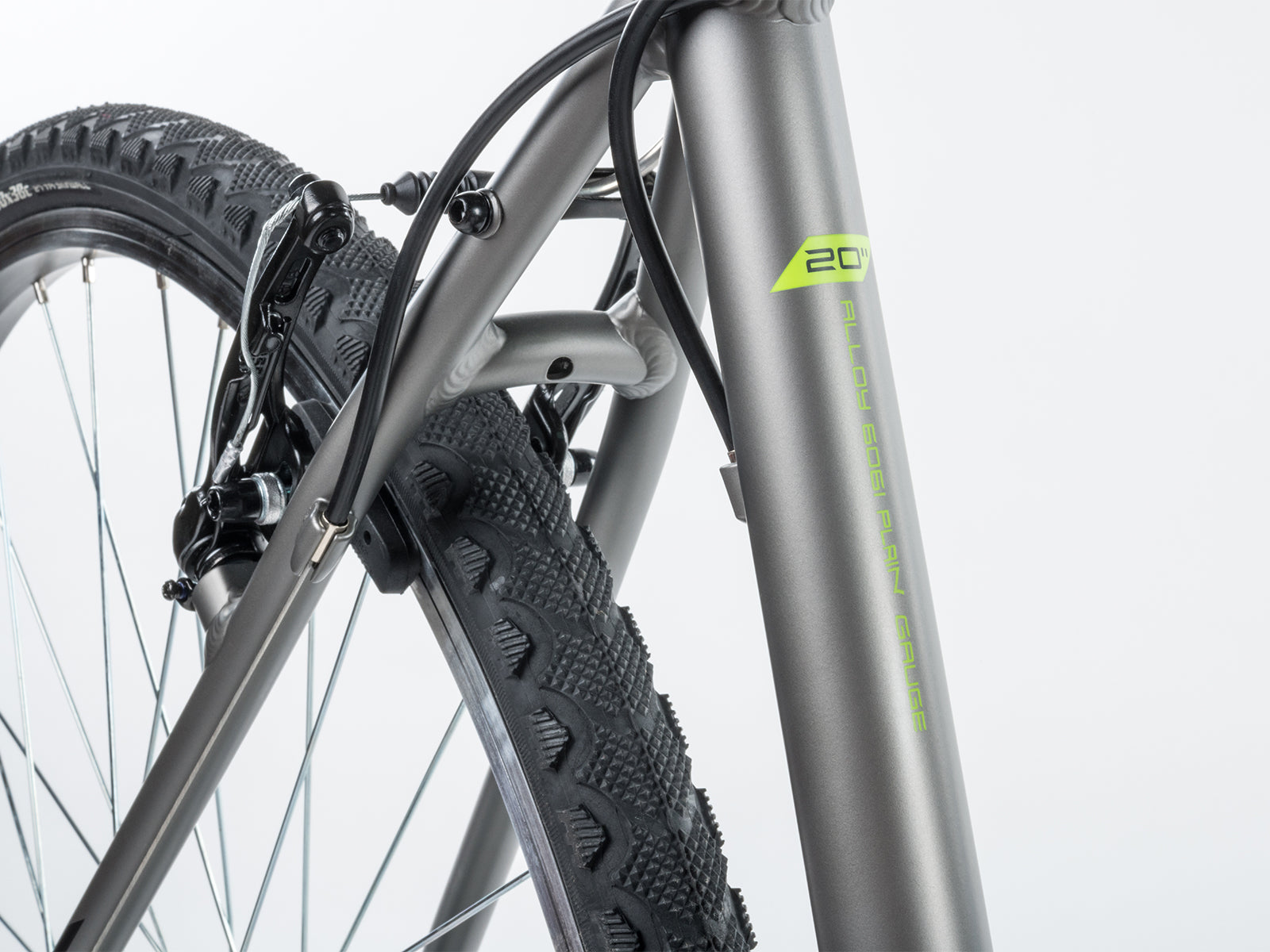 Close-up of the front end of an Author bicycle, showcasing the handlebars, brakes, and front wheel details