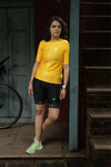 A women standing wearing yellow cycling jersey