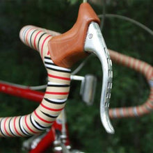 Bicycle handle featuring a striped seat and handlebar, wrapped in BTP Woven Bartape in berry brown and black colors