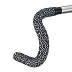  Black and white bicycle handlebar featuring a diamond-patterned BTP woven bartape