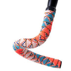  A bicycle handle bar featuring colorful, jungle summer designs on the tape, adding a lively touch to the bike's appearance