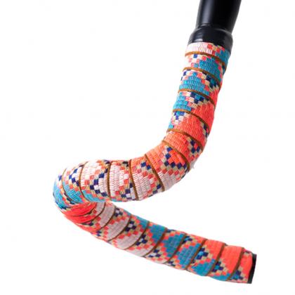  A bicycle handle bar featuring colorful, jungle summer designs on the tape, adding a lively touch to the bike's appearance