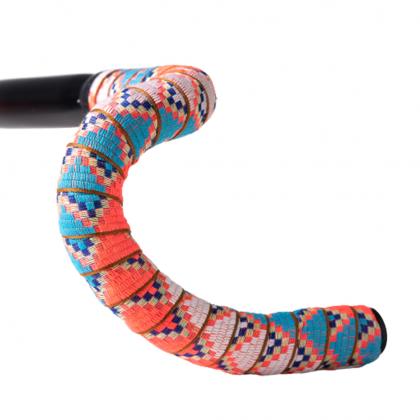 Close-up of a bicycle handle bar adorned with bright, jungle summer patterned tape, showcasing its colorful designs
