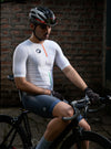 Man sitting on his cycle wearing apace brand's Bharat white cycling jersey