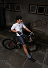 seated cyclist in apace Bharat white cycling jersey