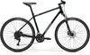 Merida Crossway 100 bicycle in black, showing its frame, suspension fork, and disc brakes.