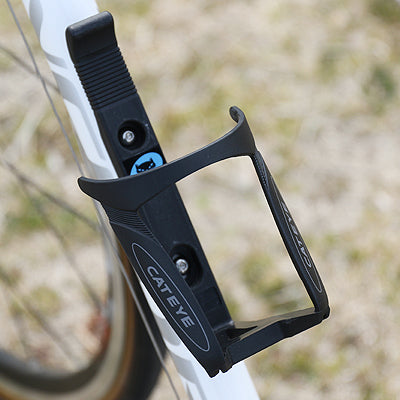 Close-up of the Cateye BC-300 bottle cage, highlighting its material and finish.