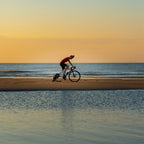 Dynamic Watt-R-Cooling Mist Spray (150ml) used by a cyclist, demonstrating its fine mist for rapid refreshment and heat management during intense rides.