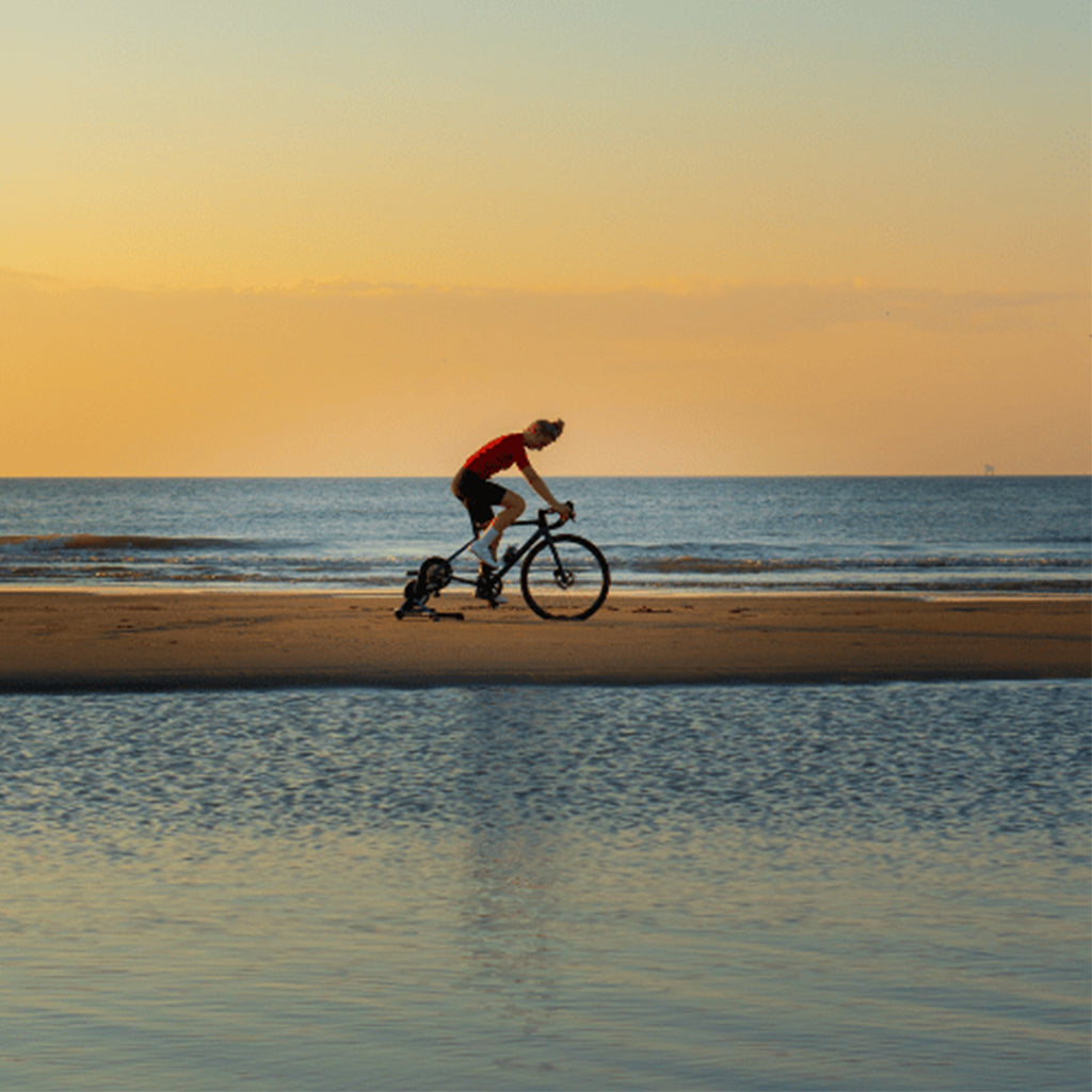 Dynamic Watt-R-Cooling Mist Spray (150ml) used by a cyclist, demonstrating its fine mist for rapid refreshment and heat management during intense rides.