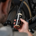 Dynamic Slick Wax (100ml) on a bicycle chain, illustrating its dry, non-sticky application for reduced dirt accumulation.