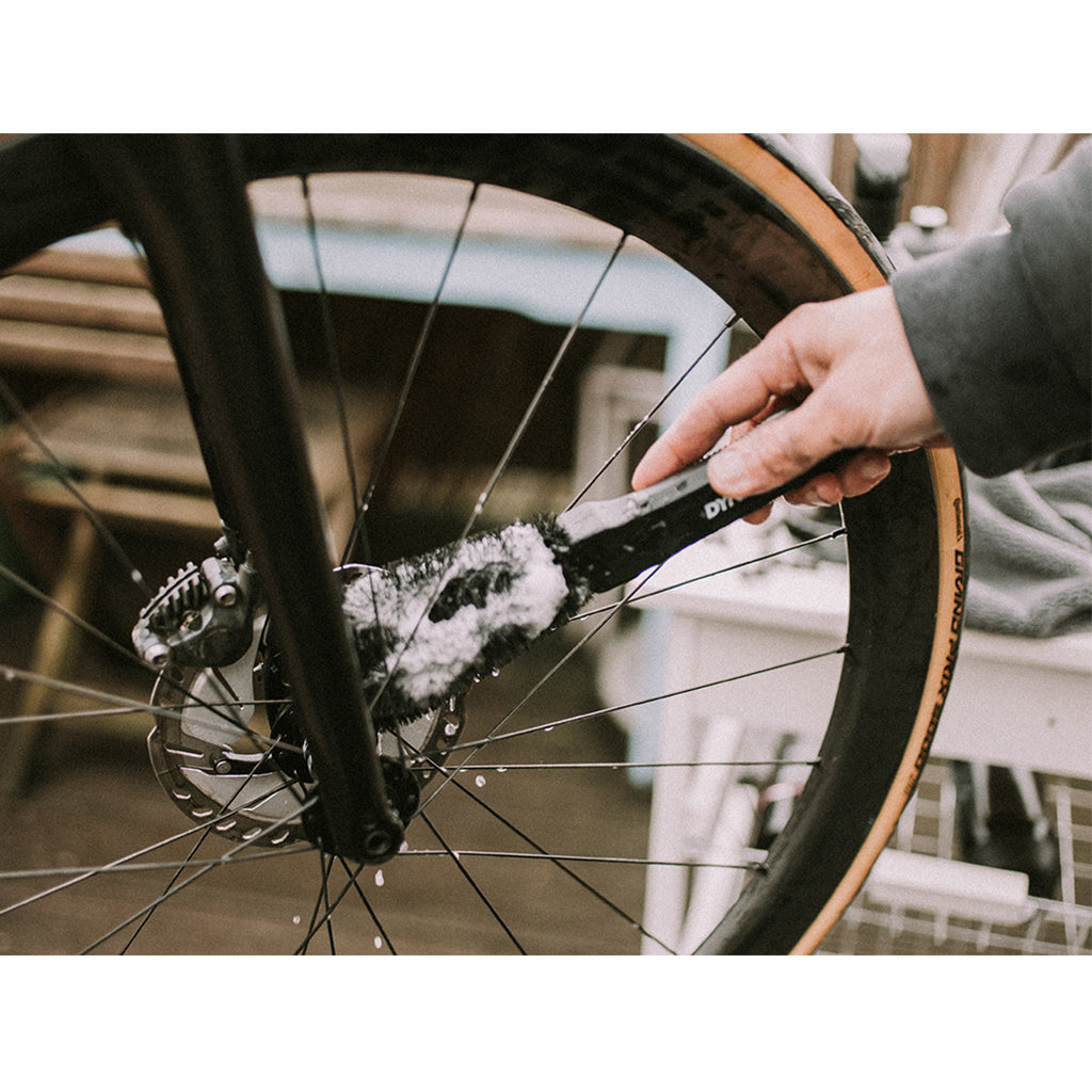 Cleaning a bike wheel with the Dynamic brush for spokes and components.

