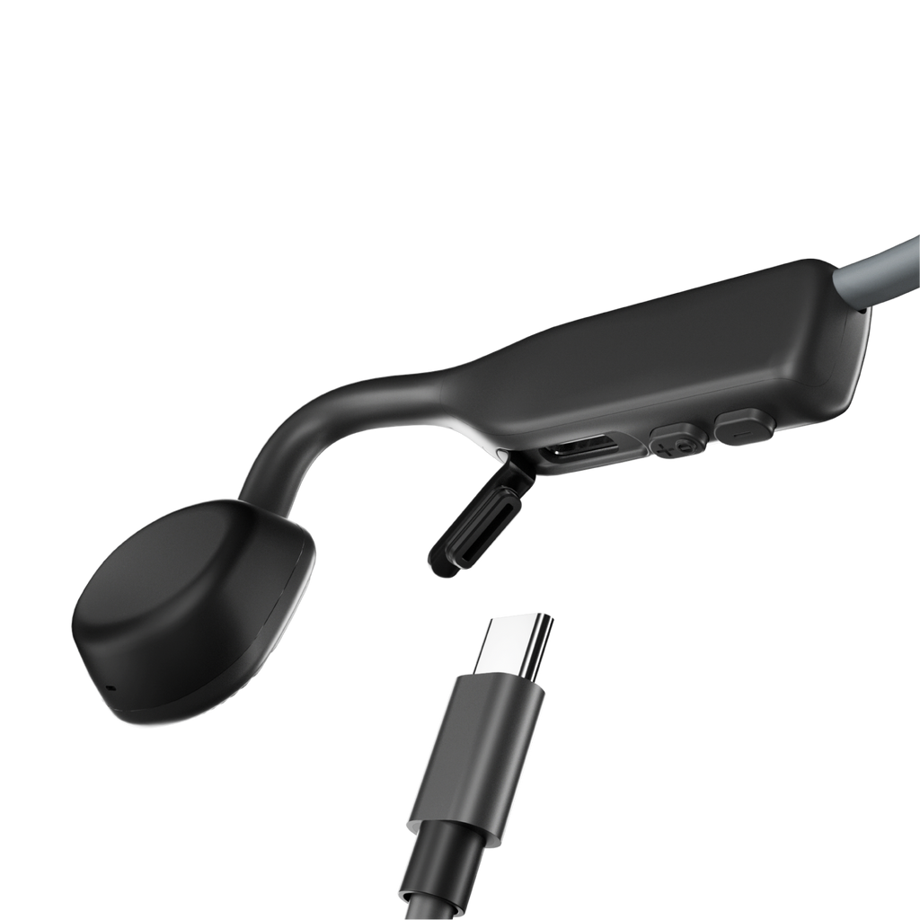 Shokz OpenMove Grey bone conduction headphones with USB-C charging cable.