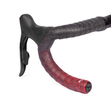 GUEE Attitude Fade Red bar tape, showing the unique red-to-black gradient and eco-friendly material on a bike's handlebars.

