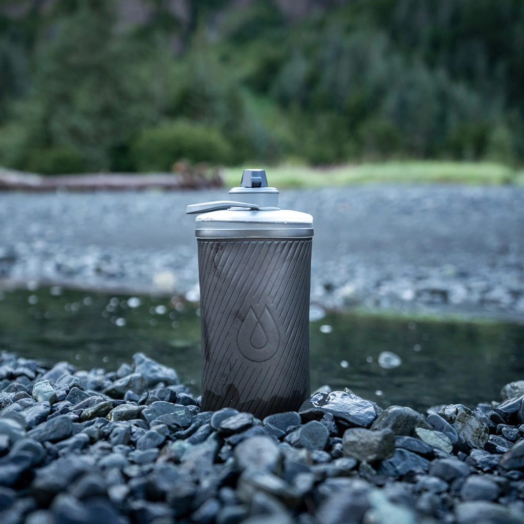 Hydrapak collapsible bottle on a camping mat – lightweight for outdoor adventures

