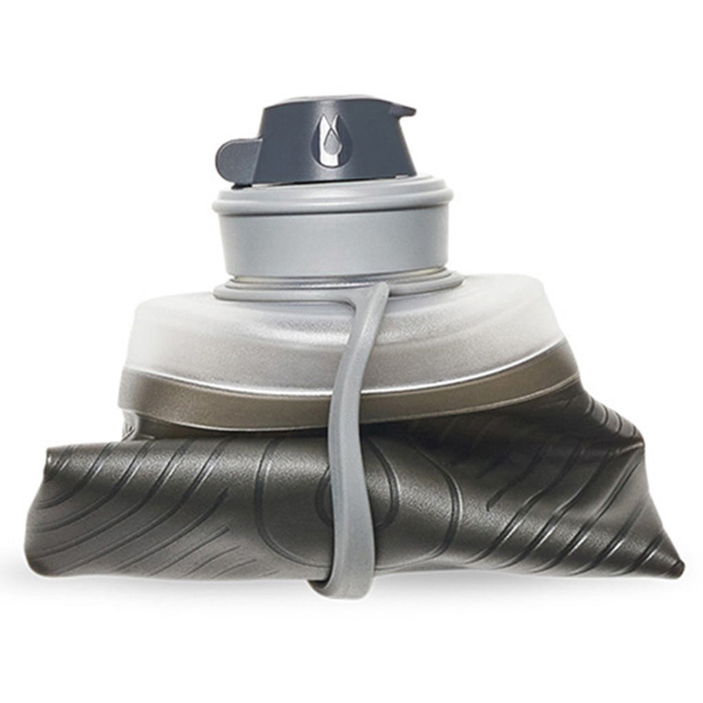 Foldable Hydrapak Mammoth Grey bottle beside camping gear space saving solution.

