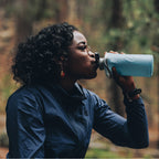 Person Drinking from a Blue Hydrapak Flux Bottle (1 Liter)
