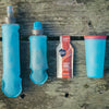 The Malibu Blue Hydrapak Softflask (250ml) shown empty and fully folded for space-saving.