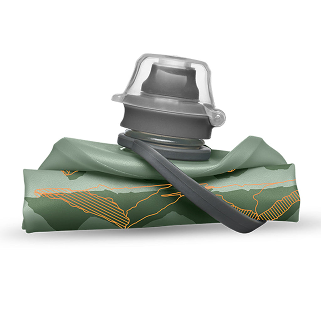 The 350ml Sutro Green Hydrapak Stow Flexible Bottle, Mountain Edition, demonstrating its ability to roll or fold for easy storage.