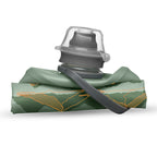 The 350ml Sutro Green Hydrapak Stow Flexible Bottle, Mountain Edition, demonstrating its ability to roll or fold for easy storage.