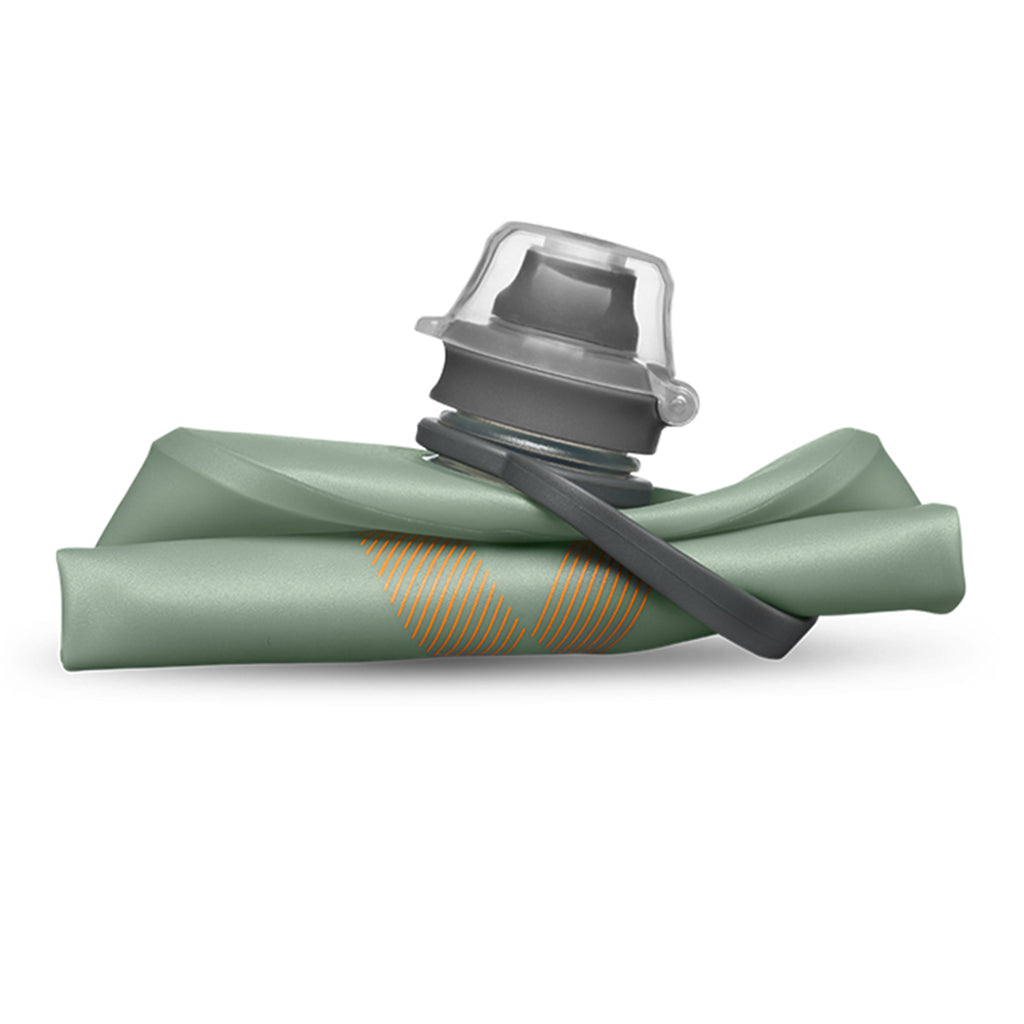 Foldable Sutro Green Hydrapak Stow 500ml, demonstrating its compact size when empty and rolled up.