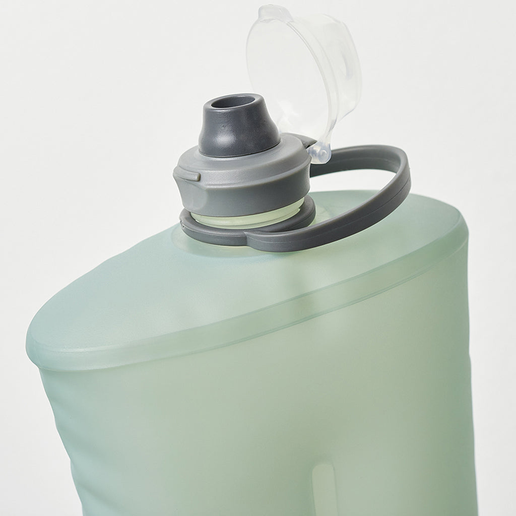Detailed view of the cap mechanism on the Sutro Green Hydrapak Stow 500ml flexible bottle.