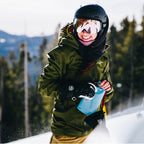 Illustrating the compact size of the Tahoe Blue Hydrapak Stow 500ml while being held during a run.