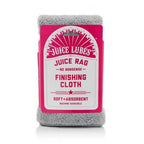 A folded yellow Juice Lubes Juice Rag microfiber finishing cloth with the brand logo clearly visible on a clean surface.

