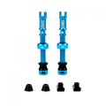 A pair of teal Juice Lubes tubeless valves (65mm) with their caps on, showcasing the vibrant color and sleek design against a clean background