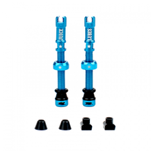 A pair of teal Juice Lubes tubeless valves (65mm) with their caps on, showcasing the vibrant color and sleek design against a clean background